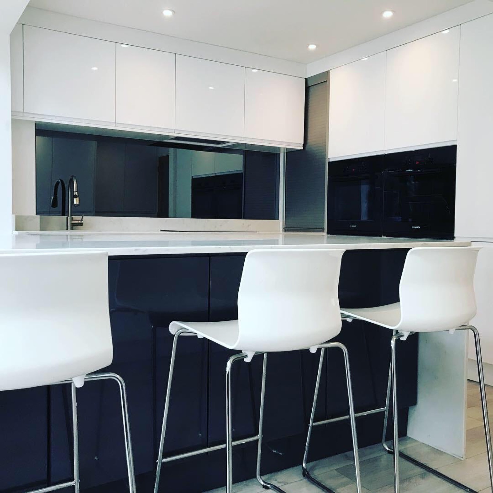 Kitchen white gloss navy island bar stools, made and fitted by Sussex Design Interiors