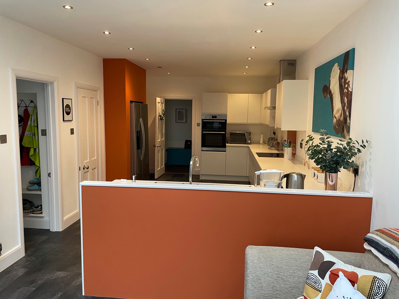 Kitchen white orange wall hallway view, made and fitted by Sussex Design Interiors