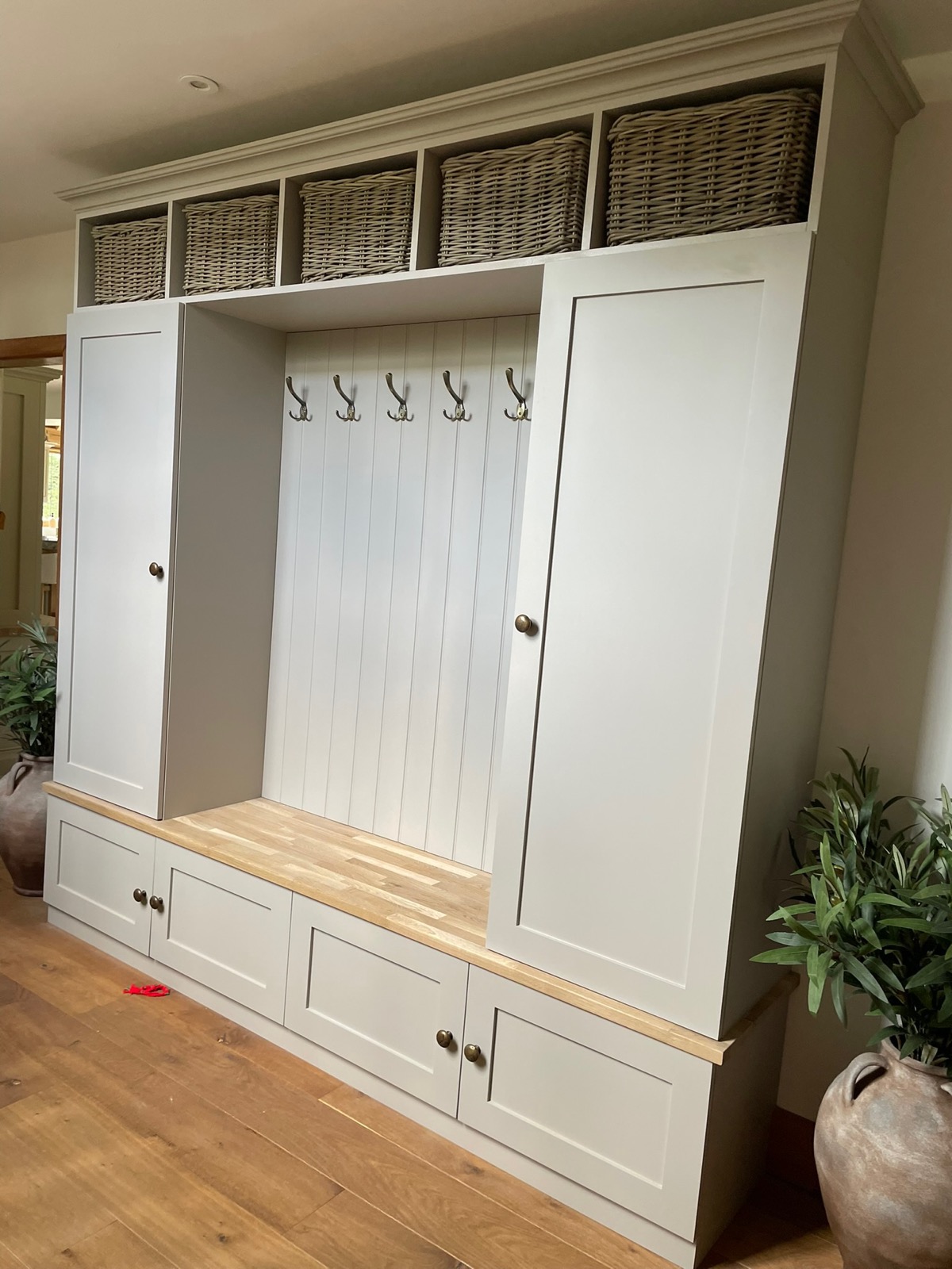 Mudroom bench hooks wicker baskets, made and fitted by Sussex Design Interiors