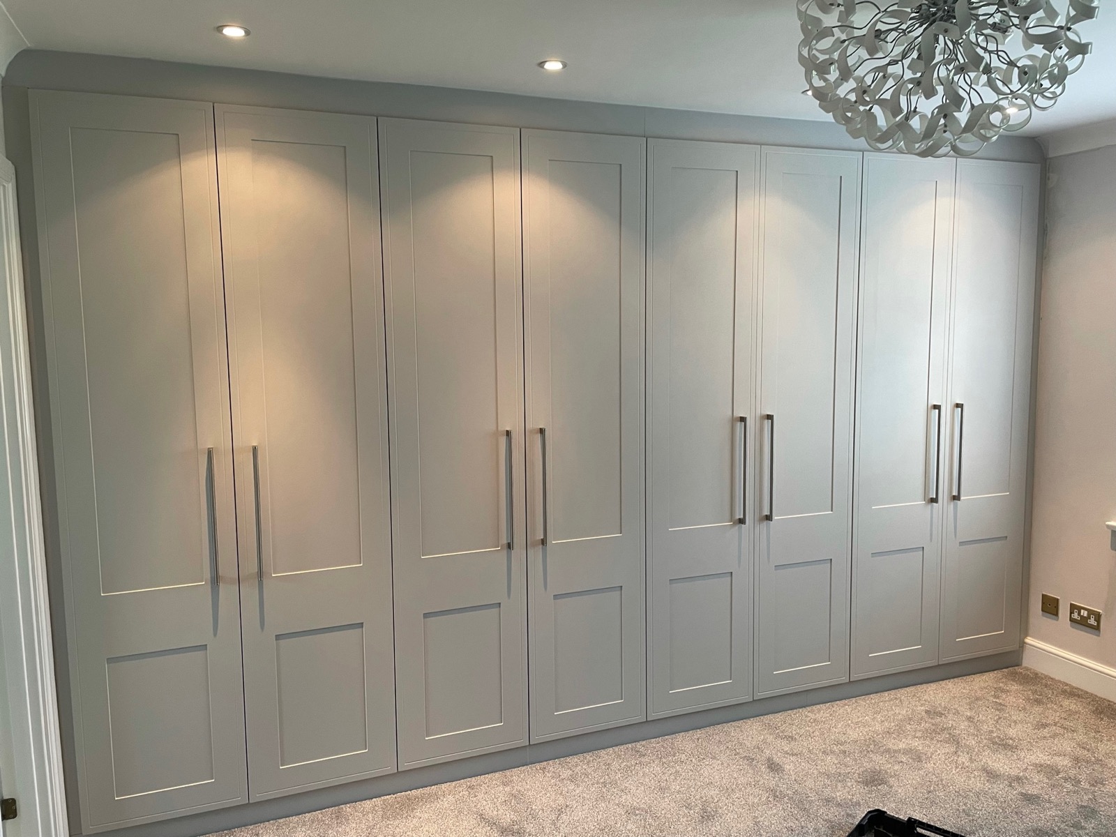 Wardrobe light grey shaker hinged doors chandelier, made and fitted by Sussex Design Interiors